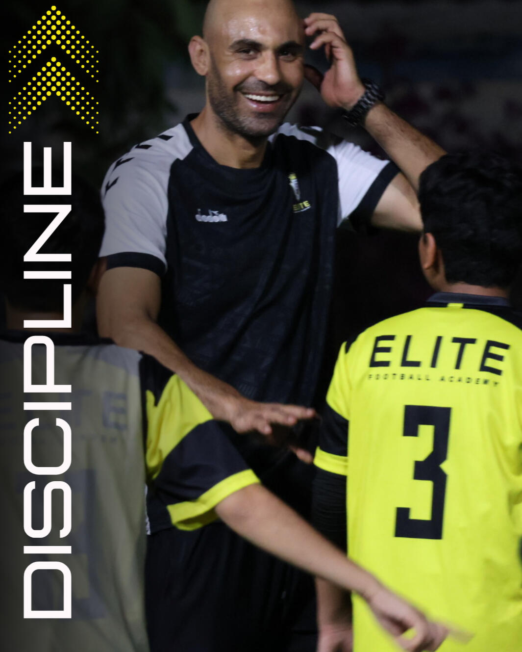 Head coach laughing and controlling a group of boys from the academy